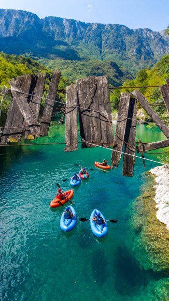 Navigating the crystal-clear rapids of the Tara River Canyon — Europe’s deepest gorge — during a guided 5-day packrafting expedition in Durmitor National Park, Montenegro. Group of adventure travelers paddling inflatable packrafts down the turquoise waters of Tara River Canyon in Montenegro
